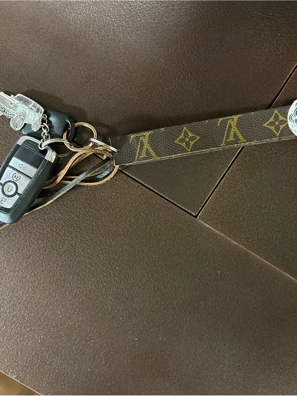 LV revamped Monogram Key Wristlet with Silver-Tone Concho and fringe
